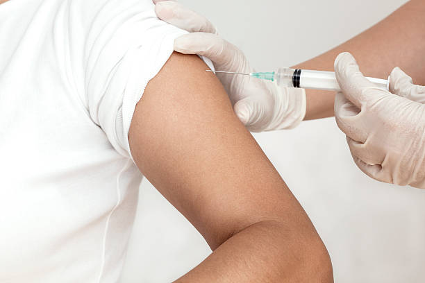 Vaccination Nurse makes vaccination of patient in a clinic, horizontal tetanus photos stock pictures, royalty-free photos & images
