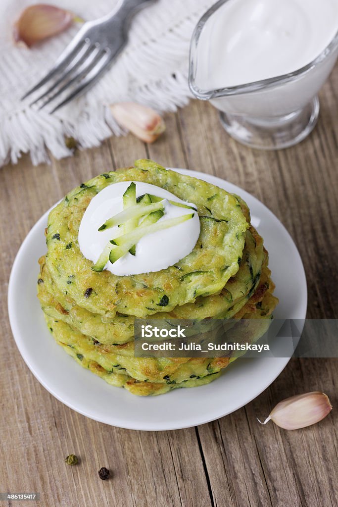 Pancakes with vegetable zucchini Pancakes with vegetable zucchini with sour cream, rustic style Appetizer Stock Photo