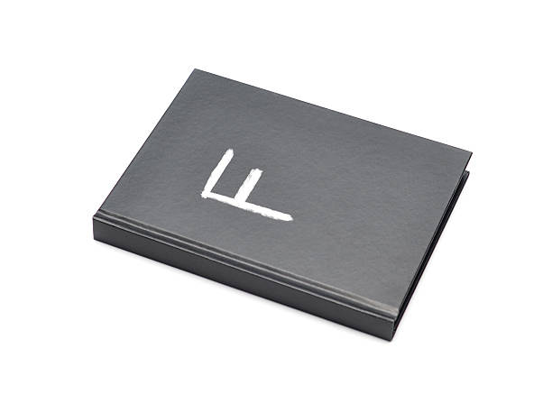 Failing Grade Closeup of a book with a chalkboard cover with the letter F on it symbolizing a failing grade. report card letter f test results education stock pictures, royalty-free photos & images
