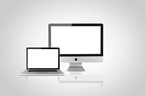 Istanbul, Turkey - August 11, 2015: Apple iMac 21'5 inch desktop computer and Macbook Pro 15 inch on white background. All devices displaying blank white screen and produced by Apple Inc.