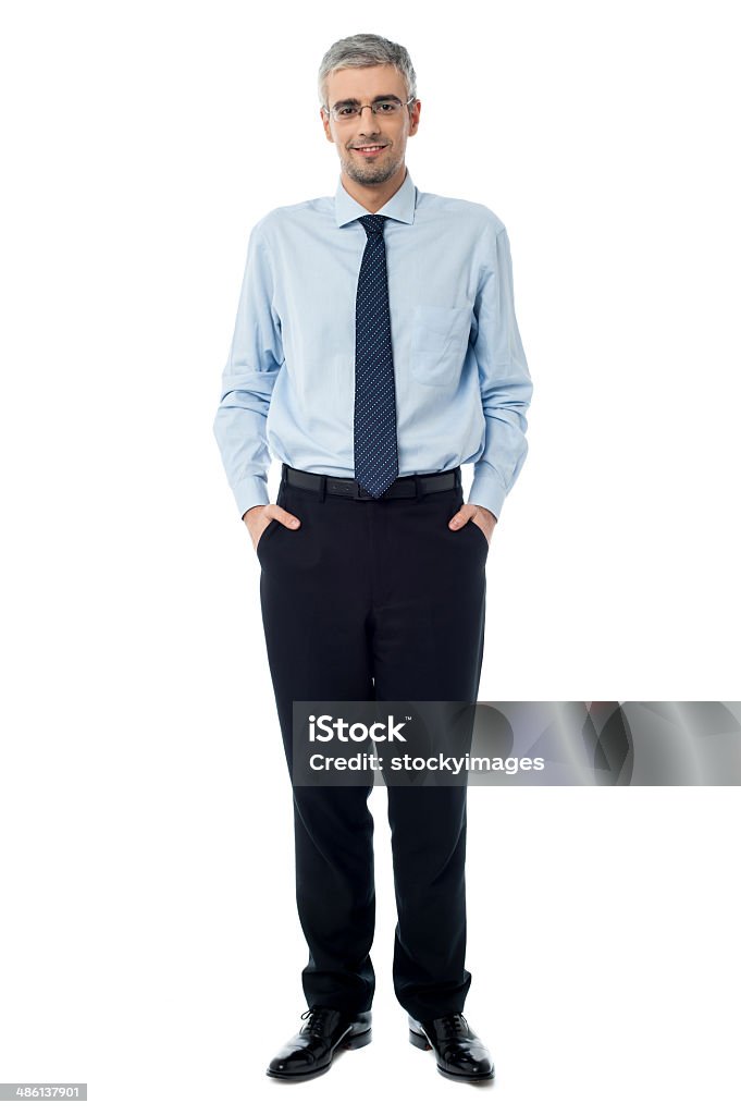 Relaxed smiling middle age business man Confident businessman with hands in pockets Adult Stock Photo