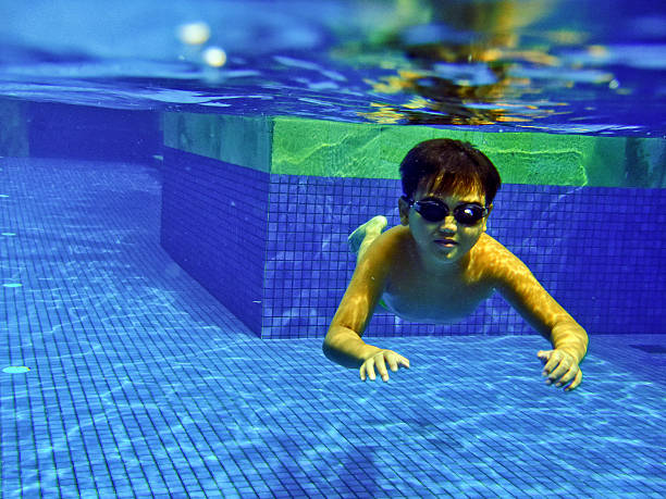istock Underwater view of boys having fun at swimming pool 2 486138570