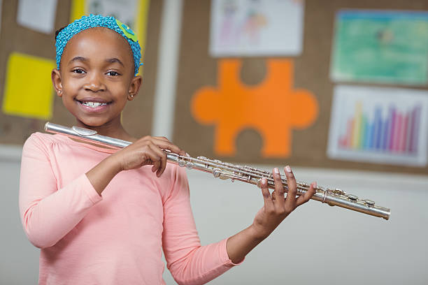 istock Cute pupil with flute in a classroom 486138852