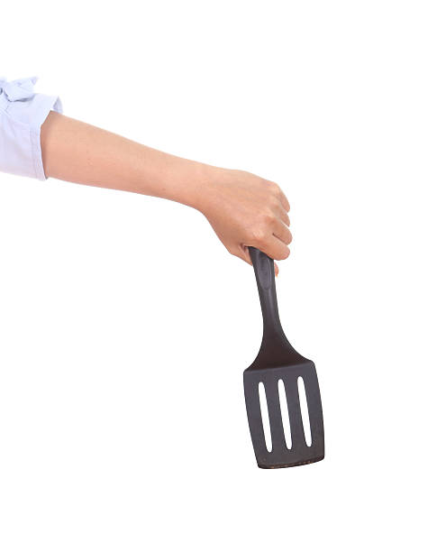 istock woman hand holding a kitchen spatula 486139463