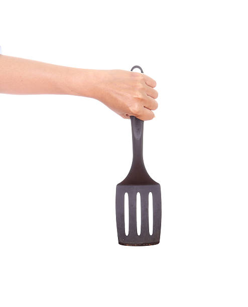 istock woman hand holding a kitchen spatula 486139465