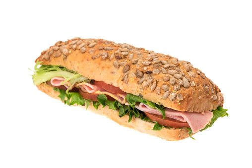 A bread ham and salad sandwich - studio shot with a white background.