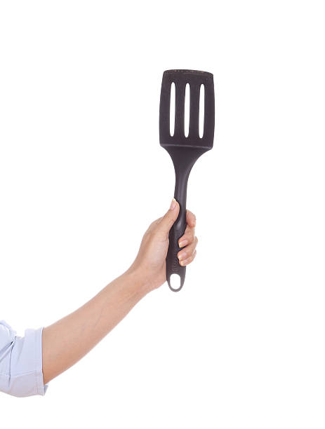 istock woman hand holding a kitchen spatula 486139537