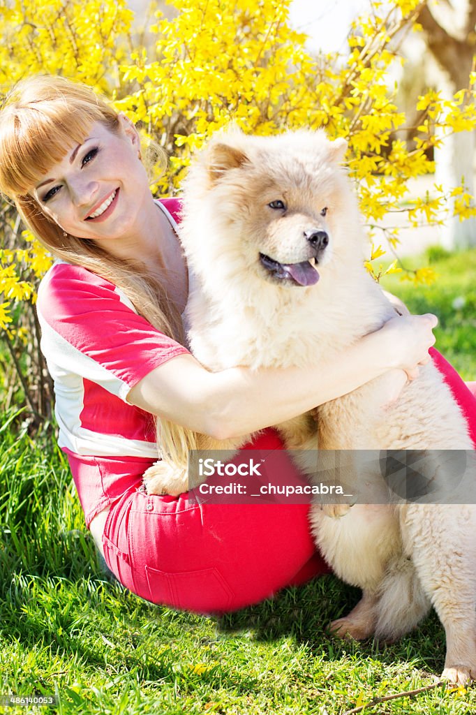 Girl with her dog on the nature Pretty girl with dog in the nature, spring time Adult Stock Photo