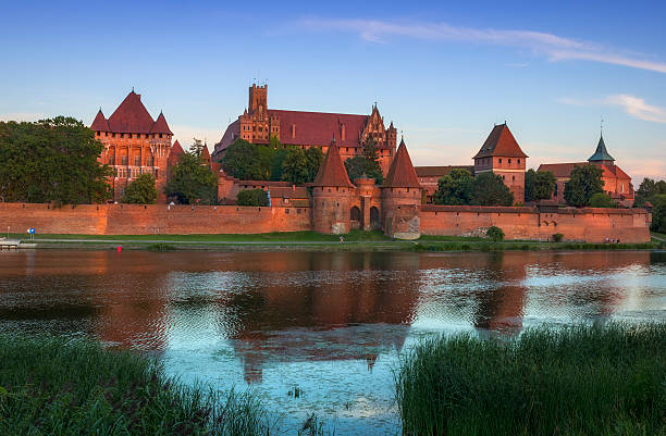 Medieval Malbork castle on the river Nogat, Poland Malbork, Poland - August 06, 2015:Medieval Malbork castle on the river Nogat, Poland. The largest castle in the world by surface area, and the largest brick building in Europe. Historical capitol of the Teutonic Order - Crusaders  marienburg stock pictures, royalty-free photos & images