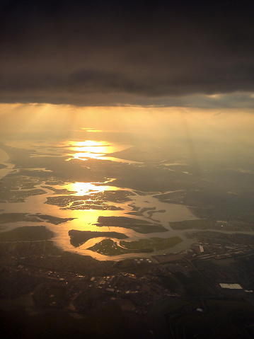 The sun sets dramatically over Oyster Bay, New York. The photo was taken while flying, with an iPhone thorugh the aircraft's window.