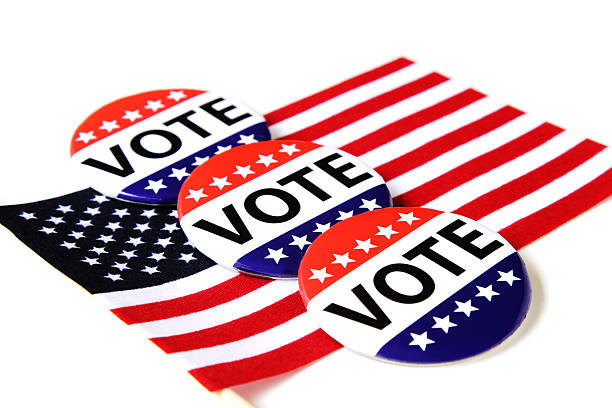 istock VOTE campaign buttons on an American flag 486140372
