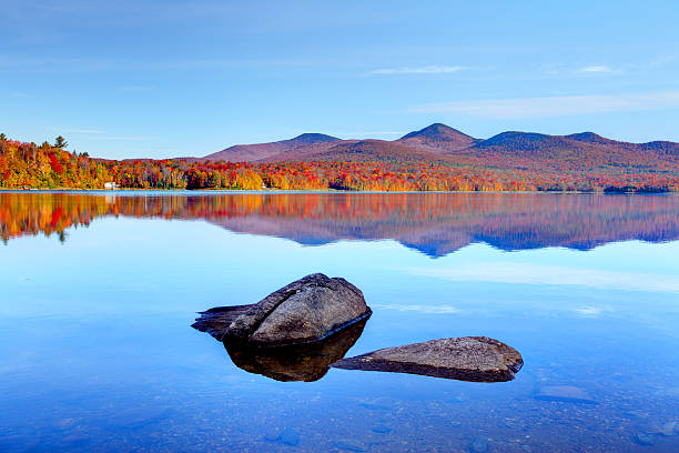 Early morning autumn in the Green Mountain National Forest in Vermont. Photo taken on a calm colorful morning during the peak autumn foliage season. Vermont's beautiful fall foliage ranks with the best in New England bringing out some of  the most colorful foliage in the United States