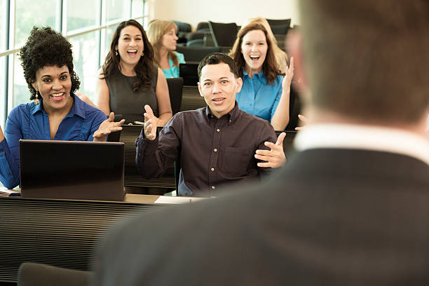 istock Education: College students with professor in lecture hall. 486141138