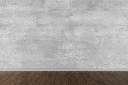 Grunge old concrete wall in empty room with hardwood floor. 3D rendered image.