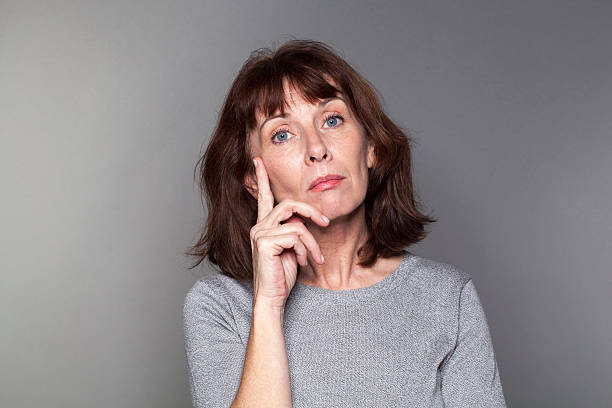 istock thoughtful beautiful 50s woman looking unhappy 486143940