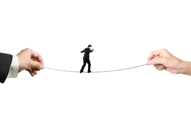 Businessman balancing on tightrope with man and woman hands holding two sides, isolated on white.