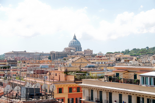 St. Peter's dome dominates Rome's rooftops on a sunny day