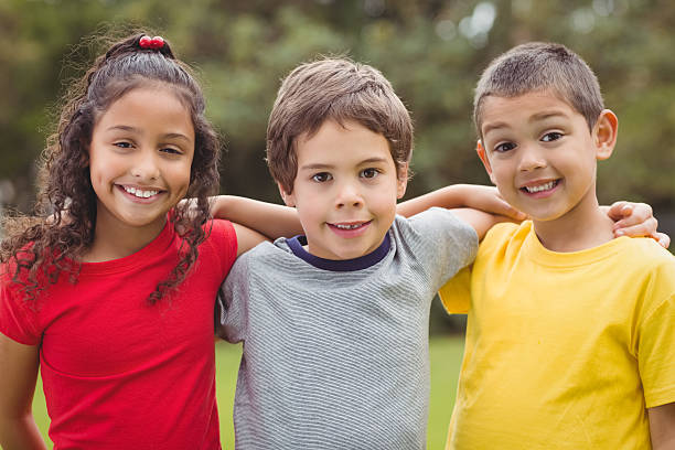 istock Cute pupils smiling at camera outside 486150102