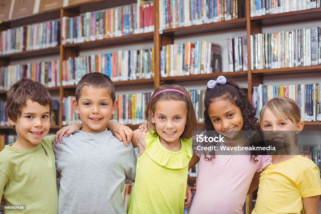 Pupils smiling at camera in library Pupils smiling at camera in library at the elementary school 2015 Stock Photo