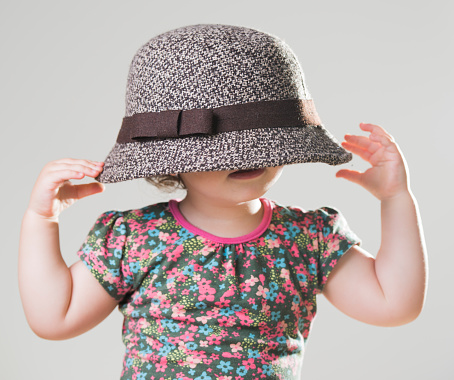 Portrait of cute little boy with sun hat on enjoying a carefree spring day in nature.