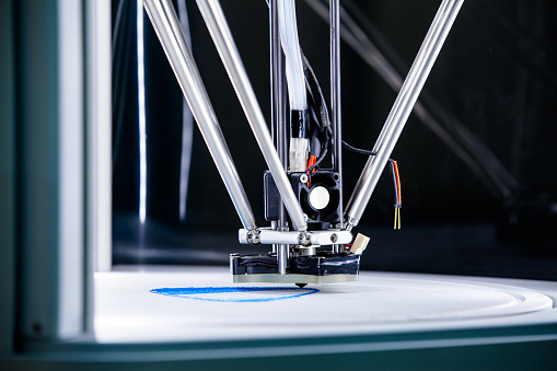 Three-dimensional 3D printer with metal print head working and creating a complex plastic prototype. HD1080 -Tripod.