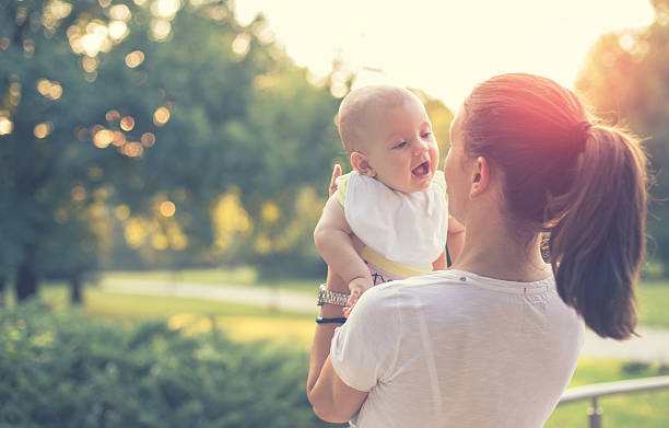 istock mother with baby in the park 486155938
