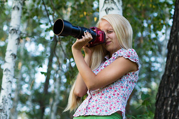 Young woman photographer in a forest