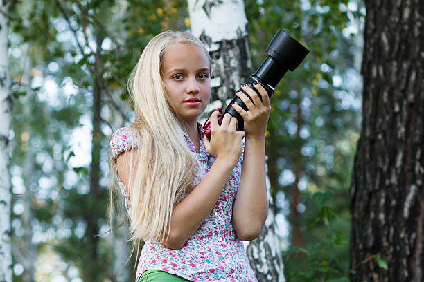 istock Young woman photographer in a forest 486159090