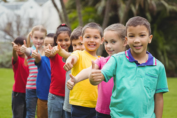 istock Cute pupils smiling at camera outside 486159660