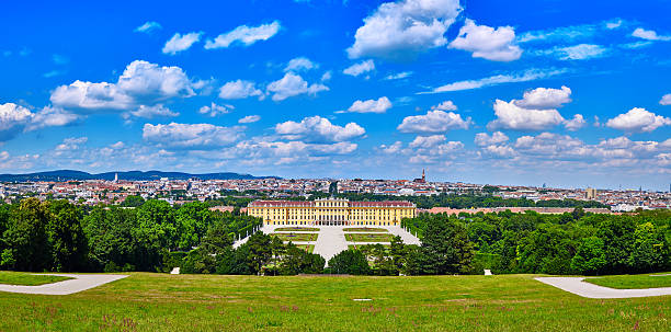 Schonbrunn palace panorama in Vienna, Austria beautiful blue cloudy sky Schonbrunn palace panorama in Vienna, Austria with beautiful blue cloudy sky habsburg dynasty stock pictures, royalty-free photos & images