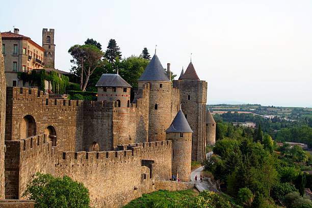 Carcassone medieval citadel at dusk. France. Carcassone, France - July 26, 2012: Medieval citadel of Carcassonne at dusk. Carcassonne is in the Aude department and chief town of the Languedoc-Roussillon region in the south-west France. Its historic center consists of a walled medieval citadel protected by UNESCO since 1997. launch tower stock pictures, royalty-free photos & images