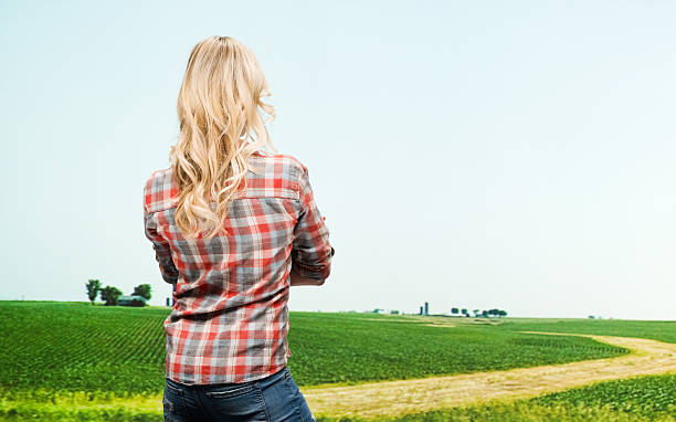 istock Rear view of farmer standing with arms crossed 486163207
