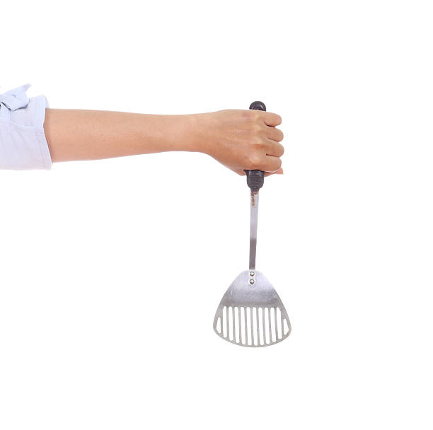 istock woman hand holding a kitchen spatula 486163219