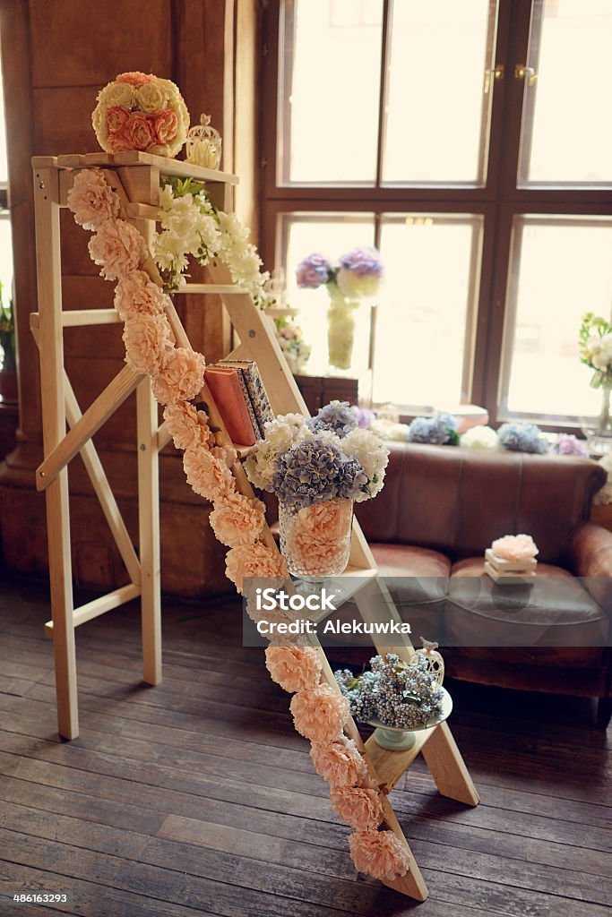 decorative interior in the room against the window with flowers decorative staircase Book Stock Photo