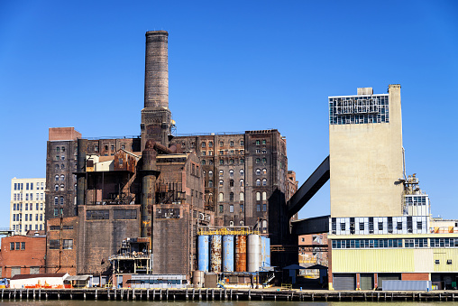 Sugar factory abandoned covered with dirt and rust in The Bronx from the hudson river, New York