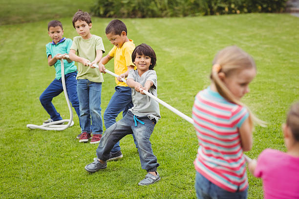 istock Cute pupils playing tug of war 486165008