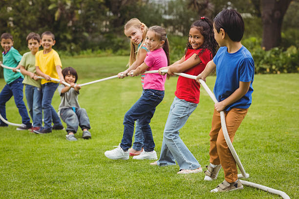 istock Cute pupils playing tug of war 486165038