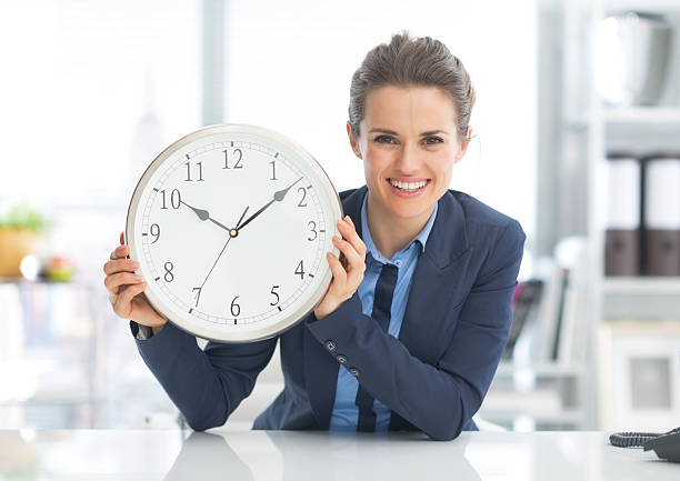istock happy business woman showing clock 486165995