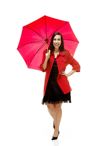 istock Happy young woman standing with umbrella 486166951
