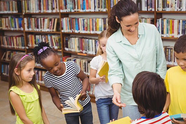 istock Pupils and teacher in the library 486167482