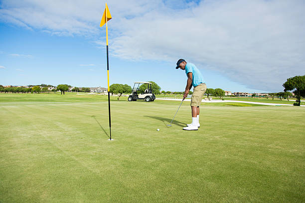 istock African golfer taking his last putt. 486168345