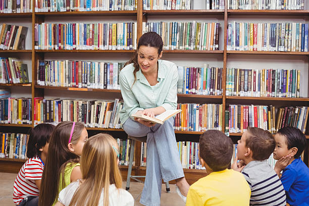 istock Teacher reading her pupils a story 486168444