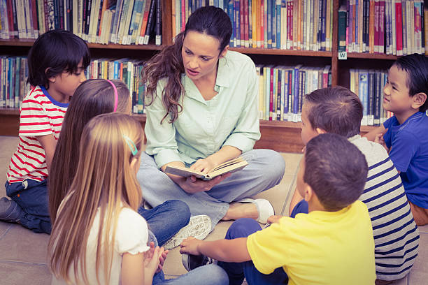 istock Teacher reading her pupils a story 486168450