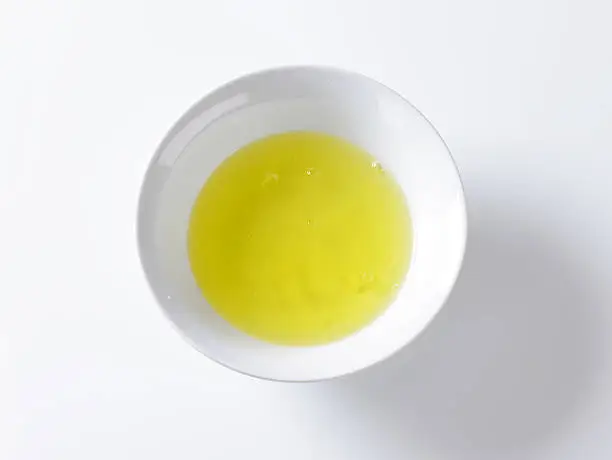 raw egg whites in white bowl on white background