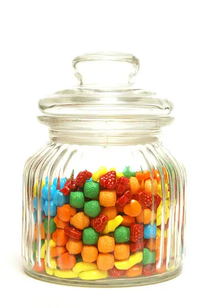 A variety of tasty candies in cliche candy jar.