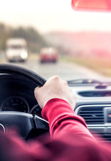 istock Man driving the car on the road 486169401