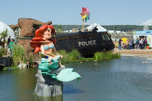 Little Mermaid and toxic Lake, Dismaland Weston-Super-Mare, UK - August 26, 2015:  The Little Mermaid mutated by chemicals at the toxic lake at Dismaland in Weston-Super-Mare.  The Banksy inspired parody fairground has attracted thousands of visitors each day. banksy stock pictures, royalty-free photos & images