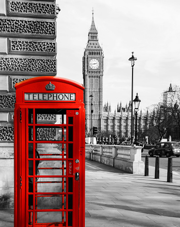 A red telephone booth in the foreground with the Big Ben behind.