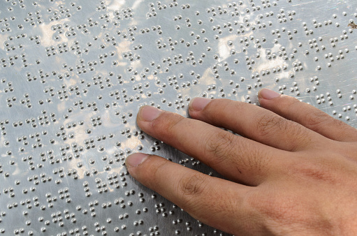 Hand reading braille