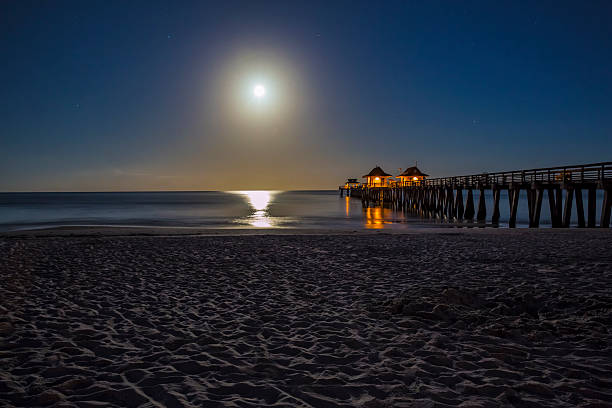 istock Early Morning Full Moon Over the Naples Pier and Beach 486171932